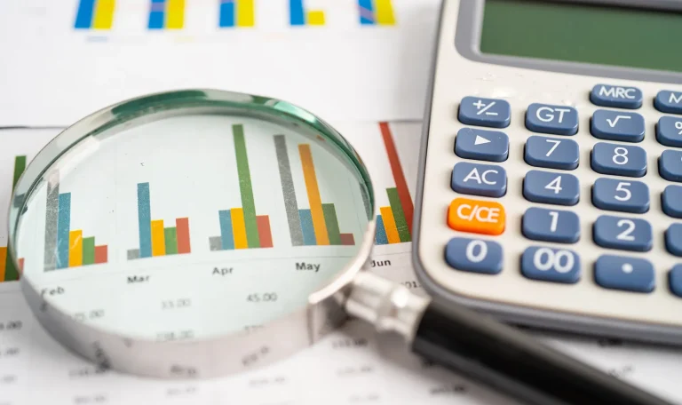 vecteezy_magnifying-glass-and-calculator-on-charts-graphs-paper_4515193 (1)